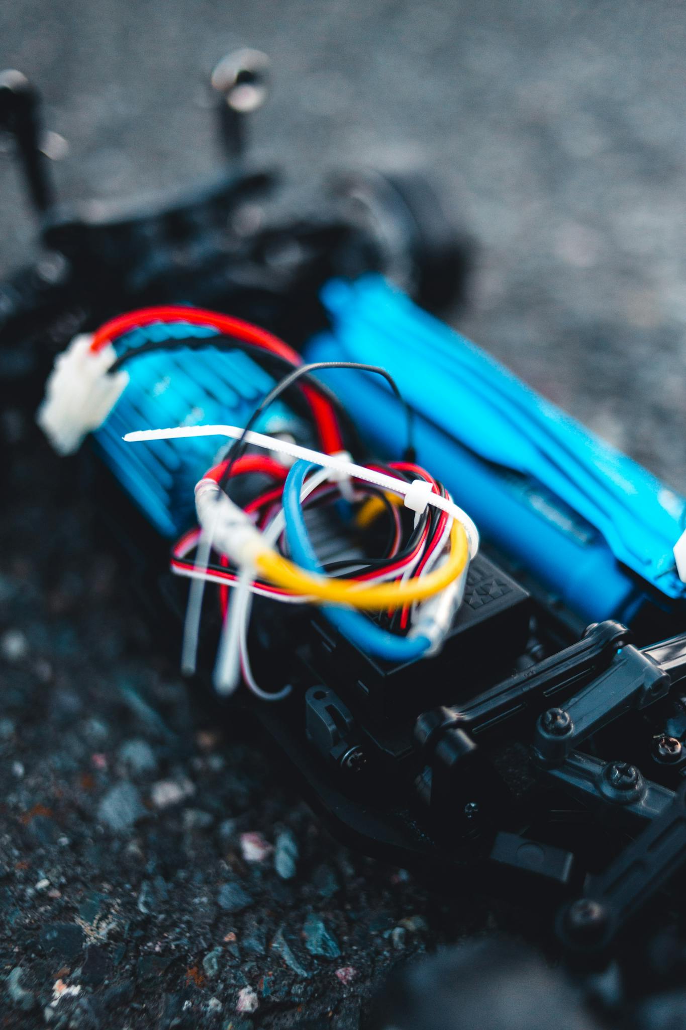 Macro shot of vibrant colored wires and components of an RC car model, showcasing detailed electronics.